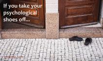 Two open doors with a pair of shoes in front of one of them 