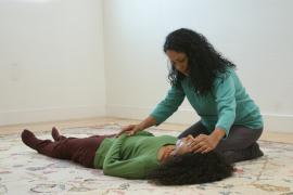 Arlie Mischeaux gives a Breema session to a woman